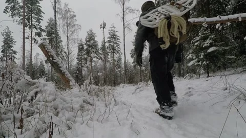Backpacker walking back and forth on a snowy path Stock Footage 145947883