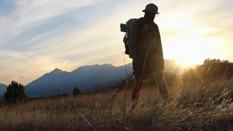 Backpacker Walking Into The Sun Stock Footage 240963188