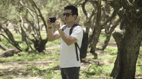 Backpacker walking through a forest exploring and enjoying nature and fresh air Video stock 273586839