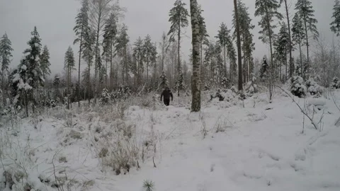Backpacker walking through snow towards camera Stock Footage 145947709