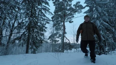 Backpacker walking towards camera on a blue coloured forest Stock Footage 146728952