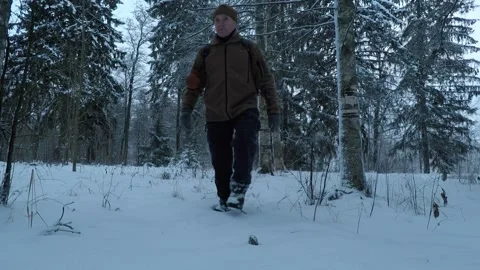Backpacker walking towards camera in snow Stock Footage 146728742