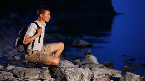 Backpacker walks on rocky coast Video stock 39589949