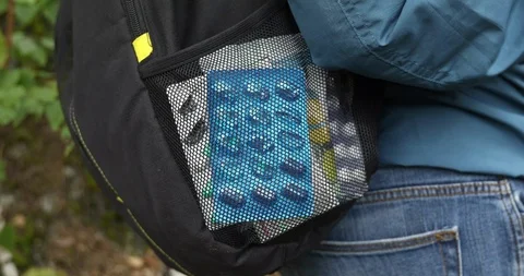 Backpacker wiht tablets and medications on a trip Stock Footage 94507386