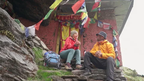 Backpackers Couple at Small Buddhist monastery decorated multicolored Tibetan pr Video stock 265774787