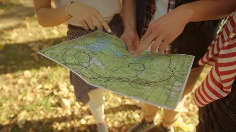 Backpackers discussing thir hiking route on traveler map Stock Footage 96238411