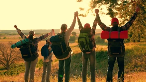 Backpackers raise their hands in celebration. Backpackers travel forest walks Stock Footage 319795666