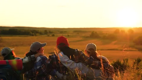 Backpackers resting sitting on top of hill enjoying nature. Tired travelers at Stock Footage 315973546