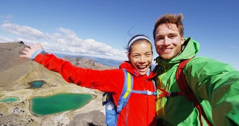 Backpackers taking selfie video against on adventure travel vacation New Zealand Stock Footage 113442373