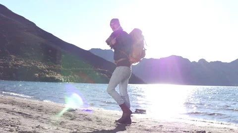 Backpacking along mountain beach alone Stock Footage 67973072