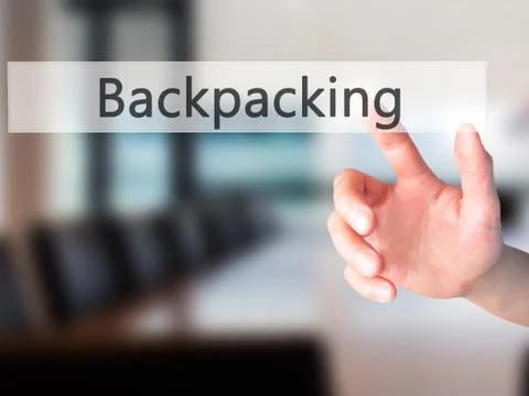 Backpacking - Hand pressing a button on blurred background concept on visual  Stock Photos