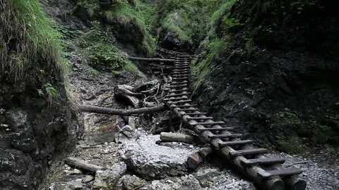 Backpacking hiker man going through rocky canyon Stock Footage 87633347