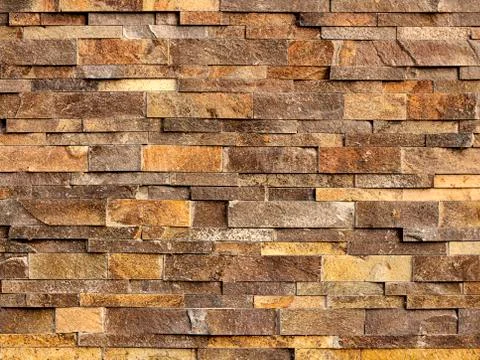 Backround texture of yellow-brown rough brick wall Foto stock