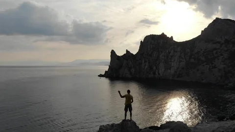 Backside aerial view man silhouette stands on hilltop Video stock 103181369