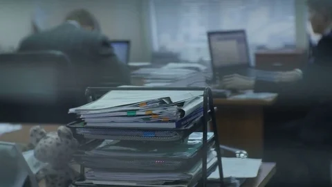 Backside Engineer Works at Computer and Folders on Foreground Stock Footage 79432633