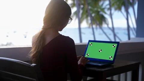 Backside long haired lady in glasses works at laptop 스톡 동영상 98808583