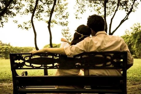 Backside of lover couples in the garden Stock Photos