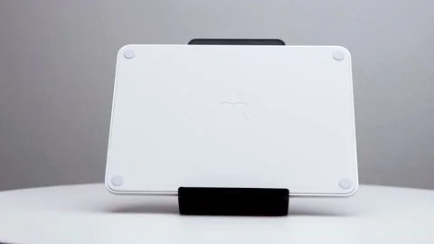 Backside magic trackpad upright on display with Apple company logo visible Stock Footage 174712548