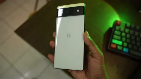 Backside of The new pixel 6 phone on hand Stock Footage 167762935