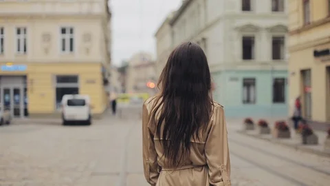 Backside Tracking Footage of Beautiful Young Girl Walking the Street Turning Stock Footage 118652186