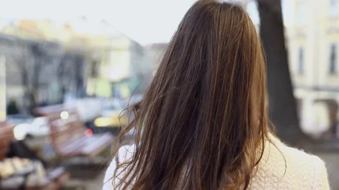 Backside Tracking Footage of Beautiful Young Girl Walking Down the Street Turnin Stock Footage 123651565