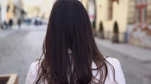 Backside Tracking Footage of Beautiful Young Girl Walking Down the Street Turnin Stock Footage 123651688