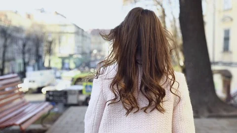 Backside Tracking Footage of Beautiful Young Girl Walking Down the Street Turnin Stock Footage 123652568