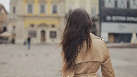 Backside Tracking of Preety Young Lady Walking the Street Sweeping the hair in Stock Footage 114416057