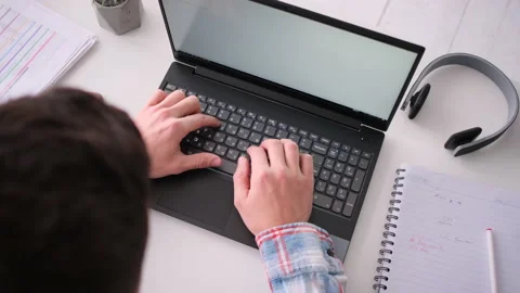 Backside view of hands typing on laptop computer at the desk Stock Footage 171542902