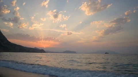 Backside view long haired girl walks into sea at sunset Video stock 102664479