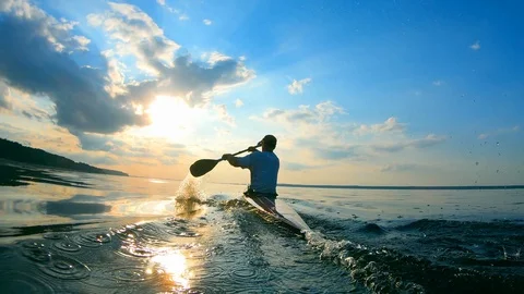 Backside view of a man sailing on a canoe Stock Footage 115770065