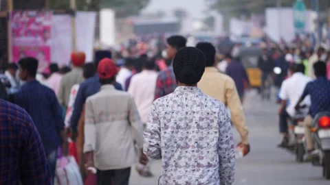 Backside view of people walking on a road Stock Footage 147706777