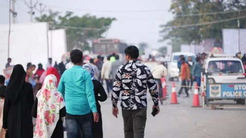 Backside view of people walking on a road Stock-Footage 147706788