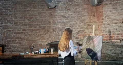 Backside view of talented innovative pretty female artist draws with brush on Stock-Footage 122542050