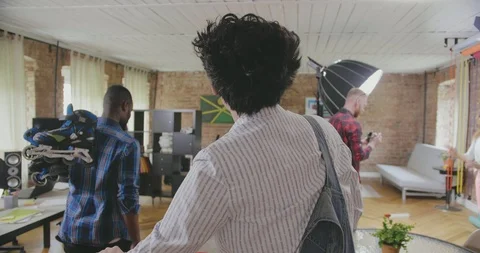 Backside view of two male multiracial colleagues who walk to their worplaces Stock Footage 112534002