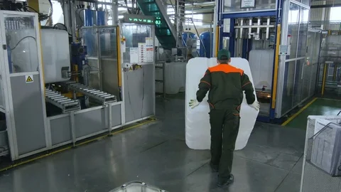 Backside View Worker Puts Container to Automatic Line Vídeos de archivo 79660165