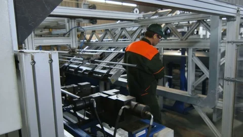 Backside View Worker Puts Metal Piece into Machine Tool Stock-Footage 79815918