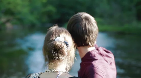 Backside view of a young couple observing summer landscape near the river Stock Footage 51666439