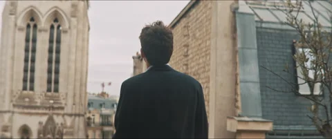 Backside of a young man staring at the cloudy sky Stock Footage 203586716