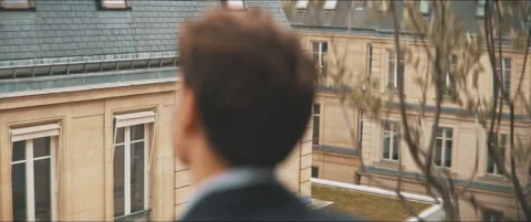 Backside of a young man staring out the street Stock Footage 203586723