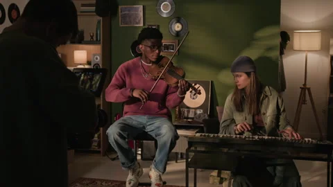 Backstage of Operator Filming Band Performing Violin and Synth in Home Studio Stock Footage 335409108