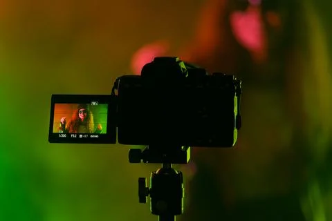 Backstage operator working professional camera. Videographer shoots music cli Stock Photos