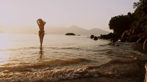 Backstage of a photo session on the beach where male photographer takes Stock Footage 343319906