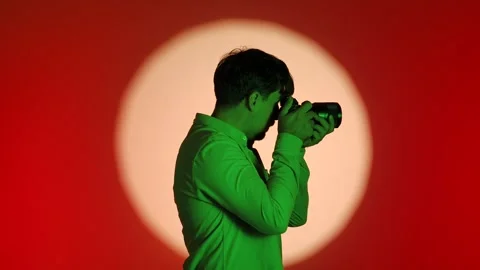 Backstage Photographer Capturing Image with Creative Lighting Setup 스톡 동영상 334108446