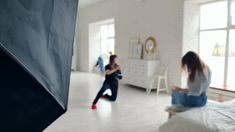 Backstage Of Photoshoot. Back view. Young girl in black tshirt making  photo. Video stock 125933693