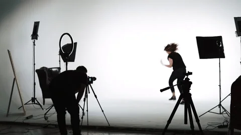 Backstage shot during video filming. white background with lots of pro equipment Stock Footage 186973607