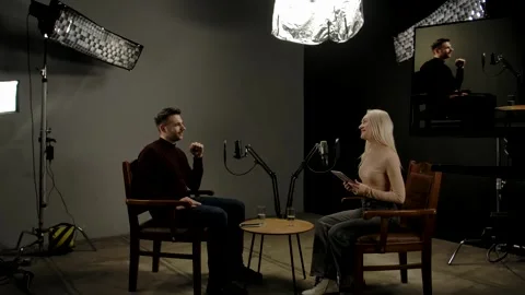 Backstage shot man host and woman guest recording interview in podcast studio Stock Footage 296763716