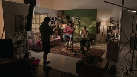 Backstage of Two Young Musicians Playing Violin and Synth in Home Setting Stock Footage 335408621