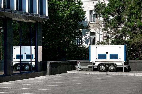 Backup Generator on the trailer with wheels. Mobile emergency Generator. Stock Photos