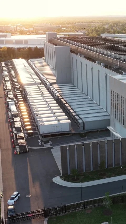 Backup generators line a data hall at golden hour in Ashburn, Virginia, cars Stock Footage 345728482